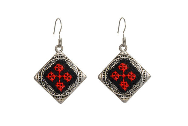 Earrings combined with traditional Arabic embroidery